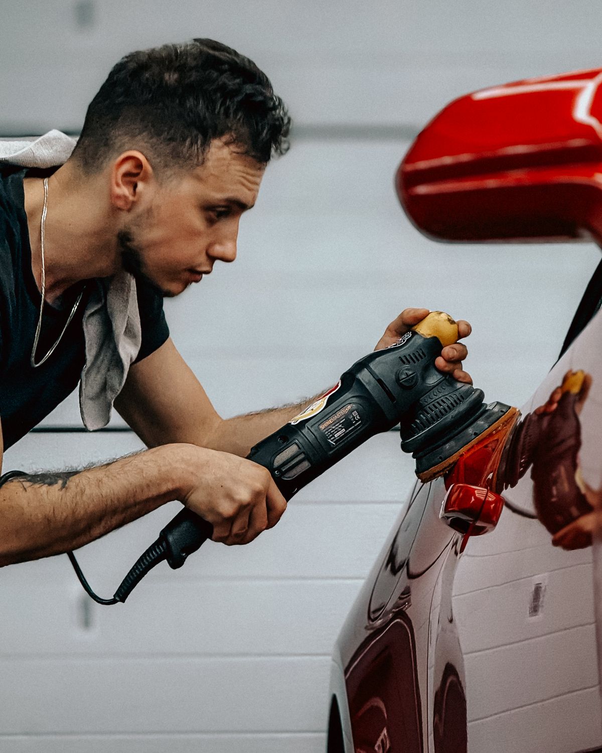 Technician restoring automotive paint